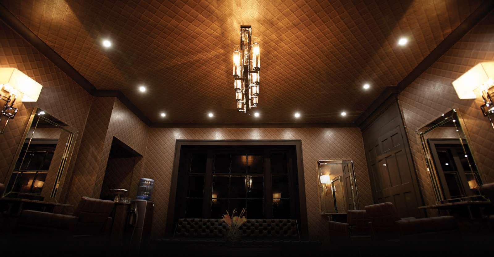 Ashley Gamble Salon, Broadway, Shifnal The colour lounge at Ashley Gamble Salon, Shifnal: panelled walls, warm lights and a glass chandelier